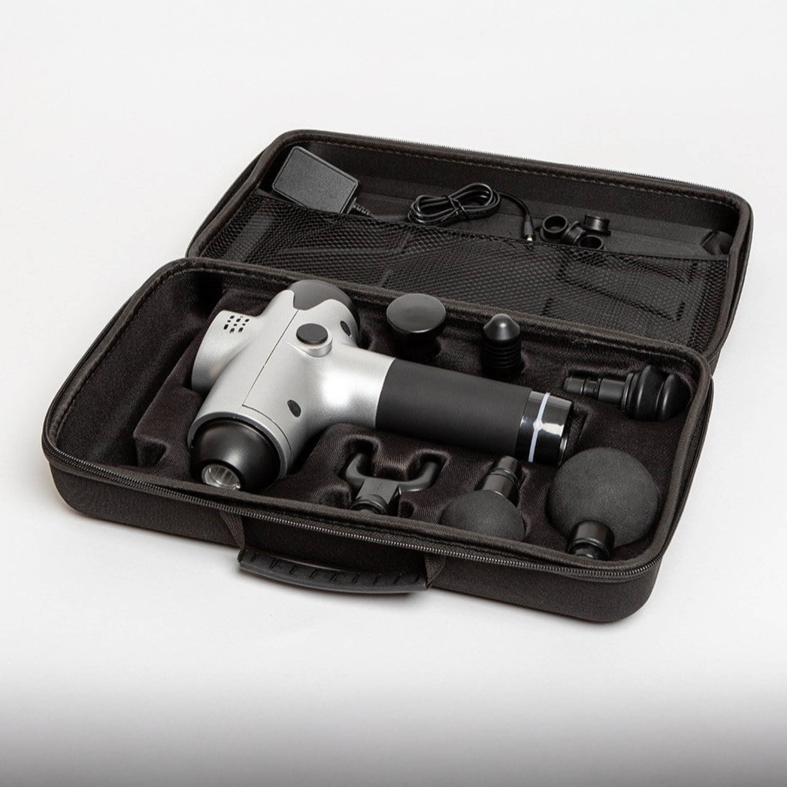 The Reviber Massage Gun by Reviber comes in a black case with multiple interchangeable heads and a charging cable, all securely organized—ideal for deep-tissue massage and muscle recovery anywhere.