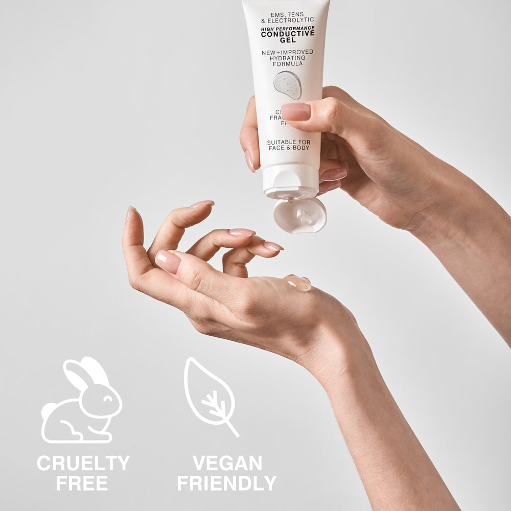 A person dispenses Reviber EMS, TENS & Micro-Current Toning Conductive Gel 85ml from a white tube onto their hand. Icons below show CRUELTY FREE (bunny) and VEGAN FRIENDLY (leaf). The gel is for face and body use.